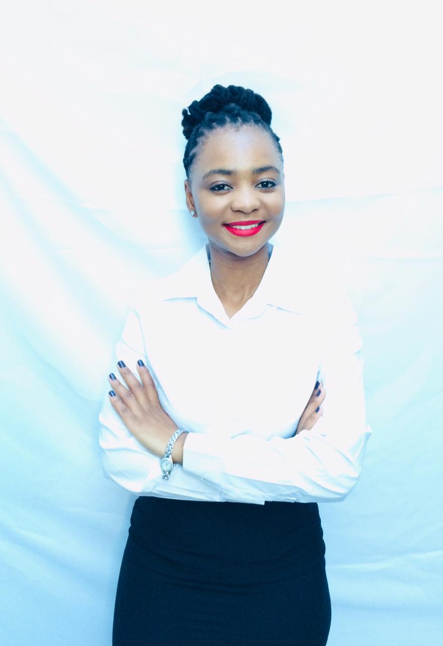 Namhla Phakamile working at a professional home office desk with a laptop, headset, and organized workspace, demonstrating the productive remote work environment used to deliver virtual assistance services